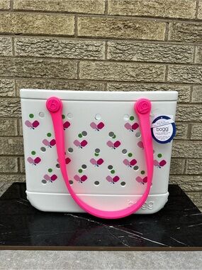 Bogg Bag featuring a playful pickleball pattern and vibrant hot pink handles